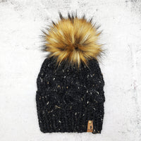 Cable beanie in Obsidian with Caramel faux fur pom
